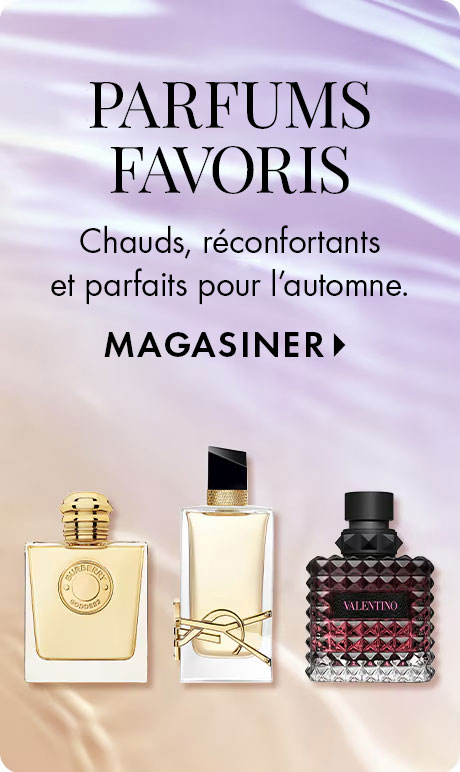 Trois flacons de parfum sont affichés avec le texte : « Chauds, réconfortants et parfaits pour l’automne. MAGASINER. » Un flacon carré à capuchon doré, un flacon rectangulaire aux accents noirs et dorés et un flacon rouge texturé étiqueté « VALENTINO ».