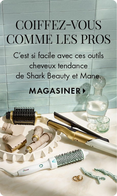 Light blue tiled background with text reading “Be Your Own Stylist” and “Trending hair tools from Shark Beauty and Mane make it easy,” plus “Shop Now.” Multiple styling tools, brushes, clips, and hair accessories are arranged on a countertop.