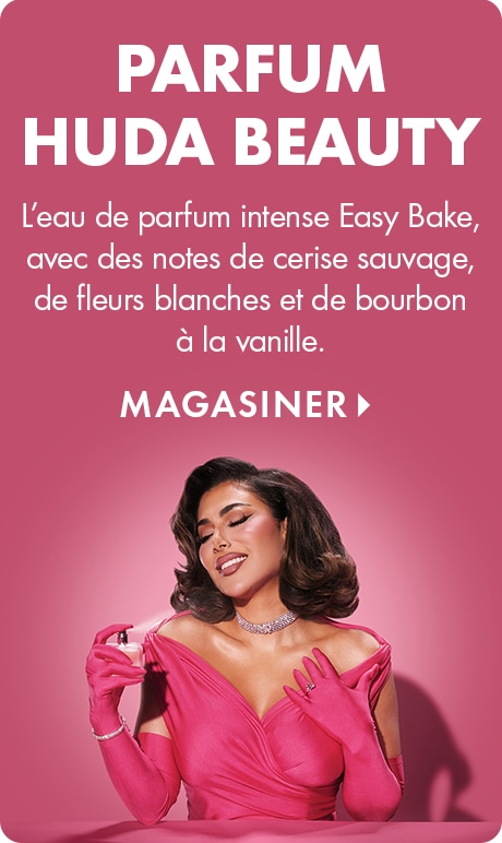 « PARFUM HUDA BEAUTY » et « Eau de parfum intense Easy Bake, avec des notes de cerise sauvage, de fleurs blanches et de bourbon à la vanille. » « MAGASINER » au-dessus d’une personne vêtue d’une tenue rose vif et de gants assortis, tenant un flacon de parf