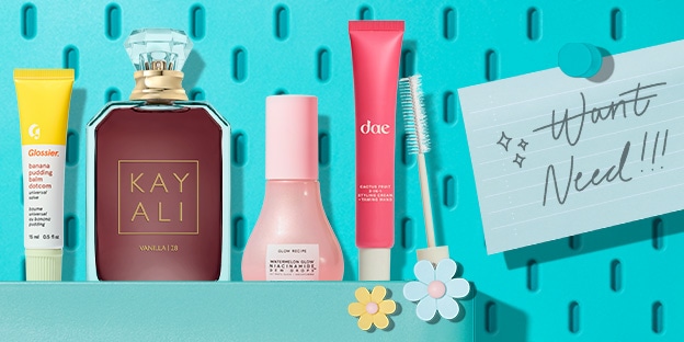 Flat lay of five beauty products on a teal perforated background: Glossier balm, KAYALI Vanilla perfume, Glow Recipe Dew Drops, dae leave-in conditioner, and an eyelash brush. A pinned note reads: 'Wants Need!!!' with the word 'Wants' crossed out.