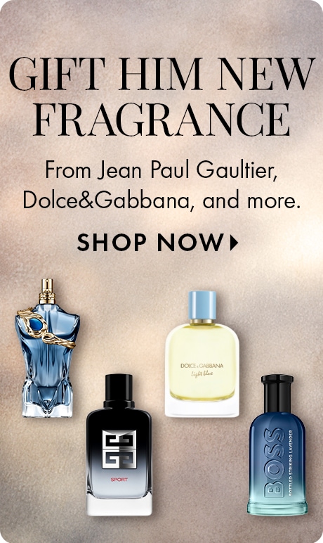 Neutral beige background with text reading “Gift Him New Fragrance” and “From Jean Paul Gaultier, Dolce&Gabbana, and more,” followed by “Shop Now.” Four men’s fragrance bottles are lined up along the bottom in different shapes and colors.
