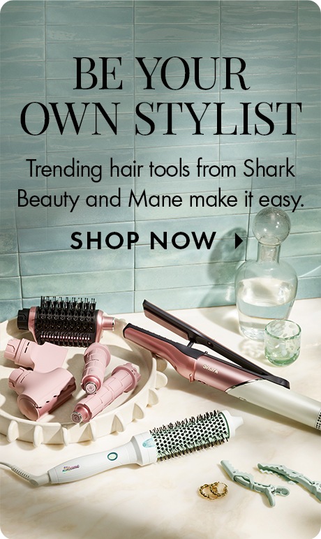 Light blue tiled background with text reading “Be Your Own Stylist” and “Trending hair tools from Shark Beauty and Mane make it easy,” plus “Shop Now.” Multiple styling tools, brushes, clips, and hair accessories are arranged on a countertop.