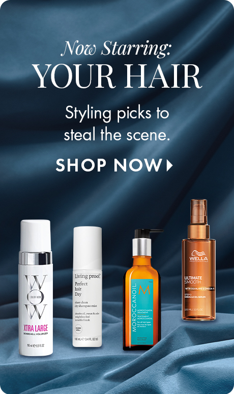 "Now Starring: YOUR HAIR" "Styling picks to steal the scene." "SHOP NOW" Four hair-care products displayed on draped blue fabric, including Color Wow, Living Proof, Moroccanoil, and Wella styling products.