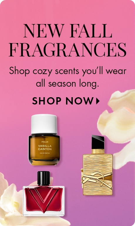 "NEW FALL FRAGRANCES" "Shop cozy scents you’ll wear all season long." "SHOP NOW" Pink gradient ad featuring perfume bottles from Phlur Vanilla Canyon, Valentino, and YSL, with soft floral petals in the background.