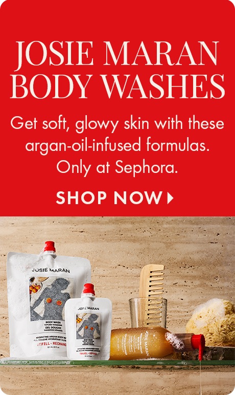 Red background with text: “Josie Maran Body Washes. Get soft, glowy skin with these argan‑oil‑infused formulas. Only at Sephora. Shop Now.” Below are Josie Maran body wash pouches, a wooden comb, a glass, a sponge, and a pump bottle on a counter.