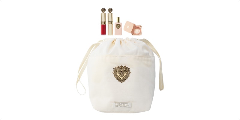 Dolce&Gabbana, featuring four minis: a liquid lipstick, mascara, fruity-floral eau de parfum, and ceramide cream & a drawstring pouch.