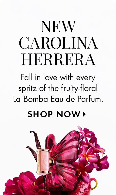White background with text reading “New Carolina Herrera.” Below: “Fall in love with every spritz of the fruity‑floral La Bomba Eau de Parfum,” followed by “Shop Now.” A pink butterfly‑shaped perfume bottle sits among flowers at the bottom.