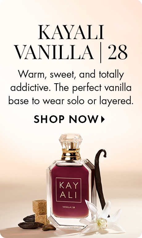 Neutral beige background with text reading “Kayali Vanilla | 28” and “Warm, sweet, and totally addictive. The perfect vanilla base to wear solo or layered,” followed by “Shop Now.” A Kayali perfume bottle sits with vanilla pods, flowers, and sugar cubes.