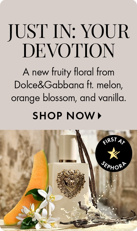 Neutral beige background with text reading “Just In: Your Devotion” and a description of a fruity floral fragrance from Dolce&Gabbana with melon, orange blossom, and vanilla, plus “Shop Now.” A perfume bottle appears with melon, flowers, and vanilla pods.