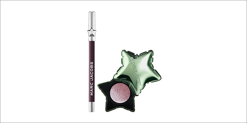 Product image on white background: deep plum Marc Jacobs eyeliner with silver ends beside a metallic green star-shaped eyeshadow compact open showing a shimmery pink shade.