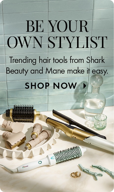 Light blue tiled background with text reading “Be Your Own Stylist” and “Trending hair tools from Shark Beauty and Mane make it easy,” plus “Shop Now.” Multiple styling tools, brushes, clips, and hair accessories are arranged on a countertop.