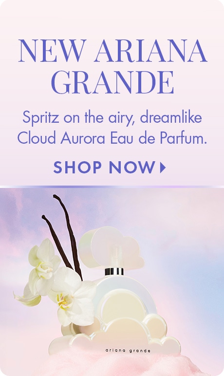 Light lavender background with text reading “New Ariana Grande” and “Spritz on the airy, dreamlike Cloud Aurora Eau de Parfum,” plus “Shop Now.” A cloud-shaped perfume bottle is displayed with white flowers and vanilla beans.