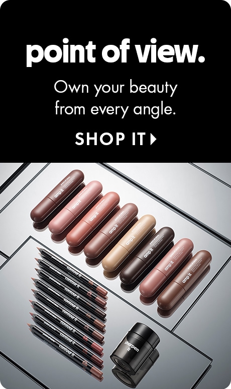 "point of view." "Own your beauty from every angle." "SHOP IT" Beauty ad with a black header and an assortment of cosmetic products displayed on mirrored surfaces below, including lip products, pencils, jars, and bottles.