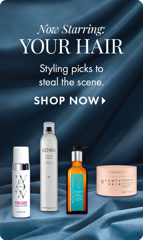 "Now Starring: YOUR HAIR" "Styling picks to steal the scene." "SHOP NOW" Beauty ad with a dark blue satin background featuring four haircare products, including Kenra Volume Spray, Moroccanoil treatment, Fenty Hair mask, and another styling product.