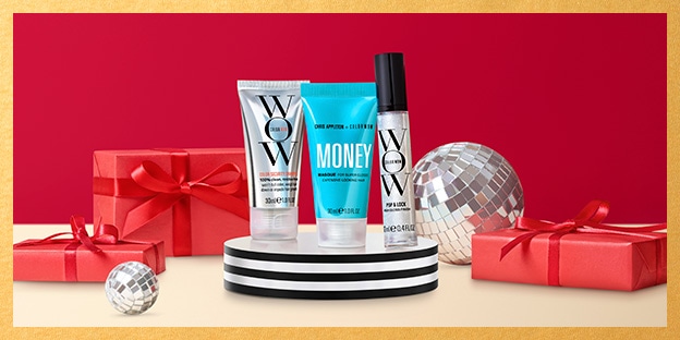 Three WOW products displayed on a black-and-white pedestal: a silver tube, blue tube labeled “MONEY,” and silver bottle. Red ribbon-wrapped gift boxes and mirrored disco balls surround the products against a red background with a gold border.