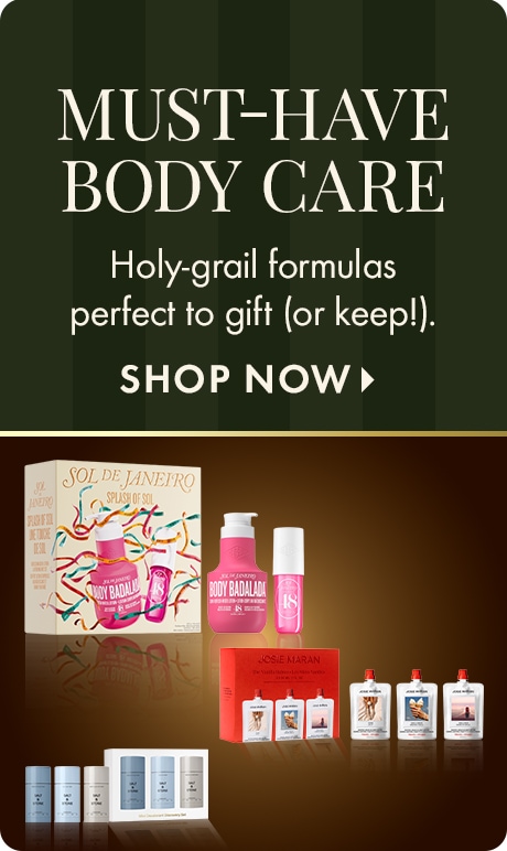 "MUST-HAVE BODY CARE." Text: "Holy-grail formulas perfect to gift (or keep!)." "SHOP NOW." Dark green striped background above beauty gift sets including pink, red, and white product packages.