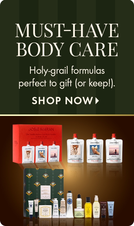 "MUST-HAVE BODY CARE." Text: "Holy-grail formulas perfect to gift (or keep!)." "SHOP NOW." Dark green striped background above assorted body-care gift sets and bottles.