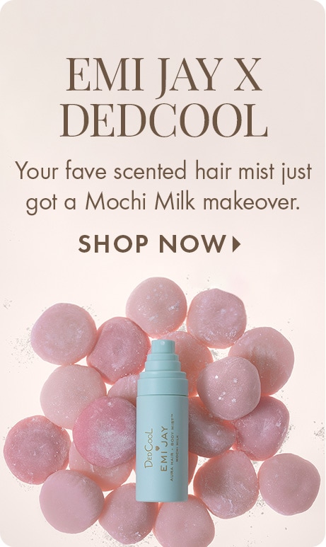 “EMI JAY X DEDCOOL” Text: “Your fave scented hair mist just got a Mochi Milk makeover.” “SHOP NOW.” Light blue DedCool x Emi Jay bottle centered in front of pink mochi-like spheres on a cream background.