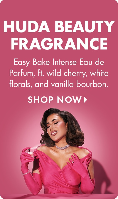 “HUDA BEAUTY FRAGRANCE” and “Easy Bake Intense Eau de Parfum, ft. wild cherry, white florals, and vanilla bourbon.” “SHOP NOW” above a person in a bright pink outfit and matching gloves holding a perfume bottle against a pink background.