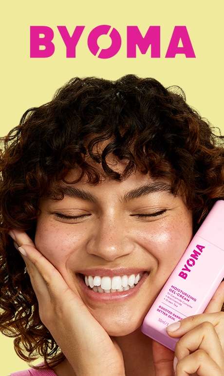 BYOMA. Boosted Barrier. Better Skin. Image of model holding product.