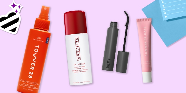 Four beauty products on a lavender background: an orange Tower 28 spray bottle, a red-and-white ONE/SIZE bottle, a gray REFY mascara with wand, and a pink Summer Fridays tube. Decorative heart sticker and blue paper accents appear in the corners.